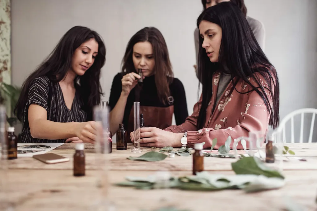 Girls smelling perfume out of vials and bottles