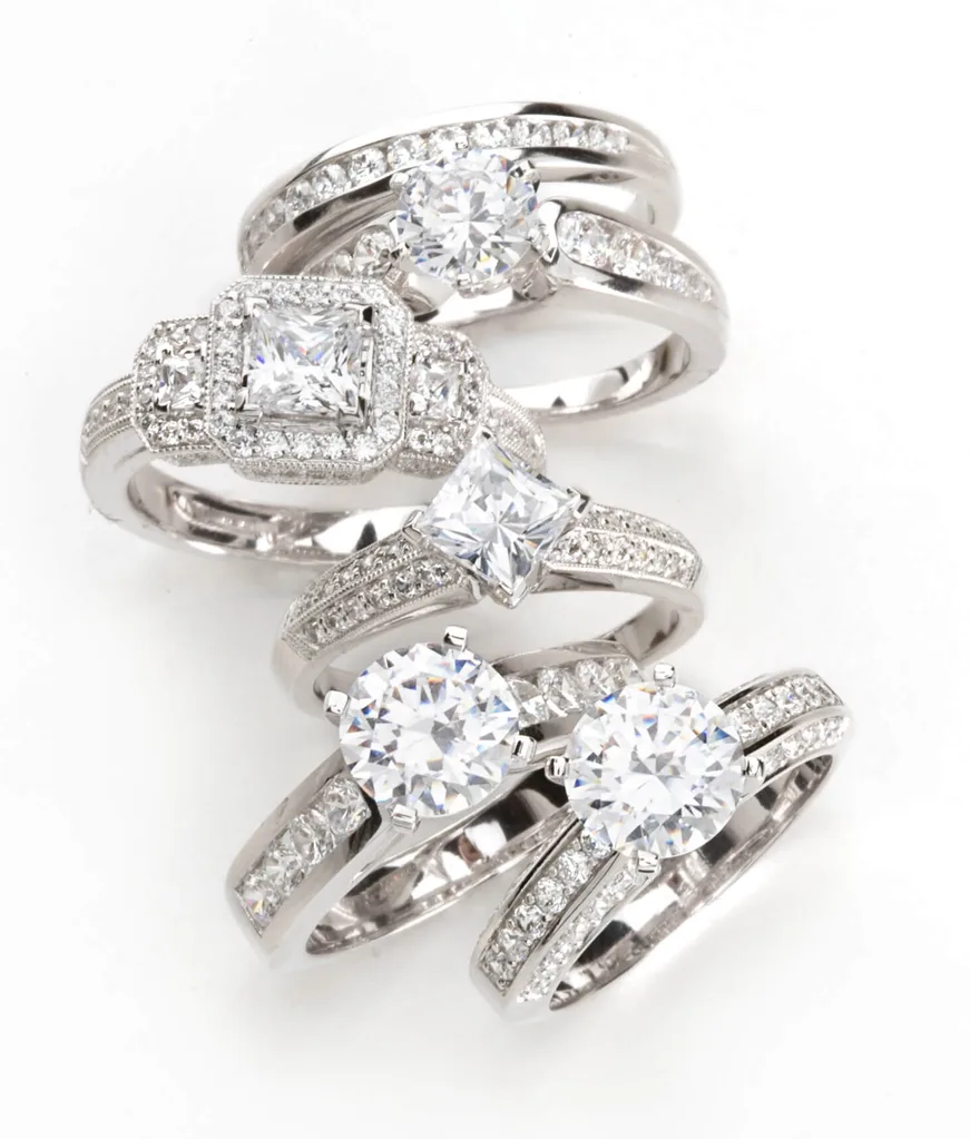 Silver diamond rings on a white background