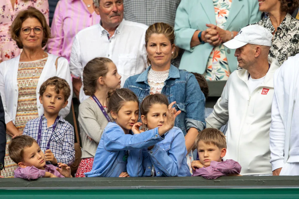 Mirka Federer watching a tennis match in a crowd