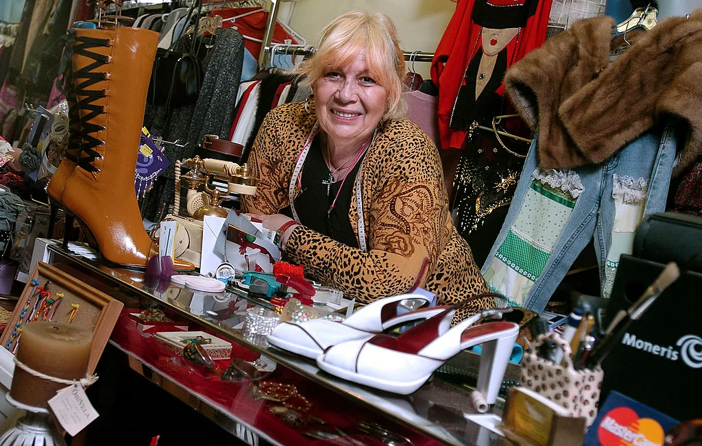 The owner of Mira's Vintage and Consignment store behind the counter of her shop