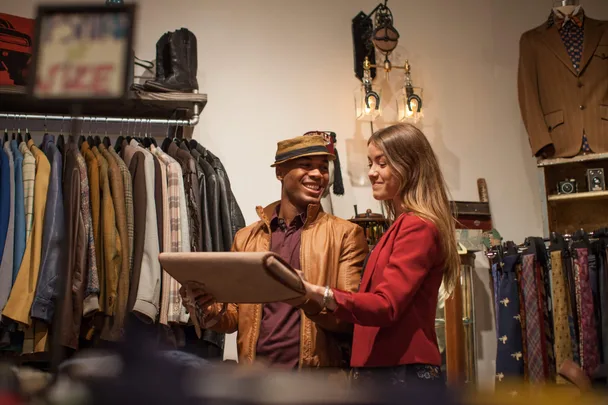 A young couple shopping in a vintage clothing store