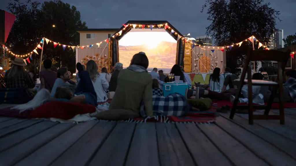 A woman watching a movie in an outdoor cinema