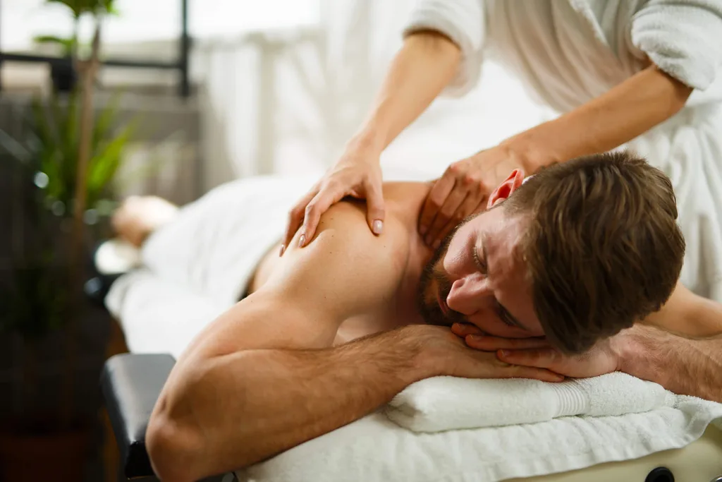 A massage therapist massaging a man