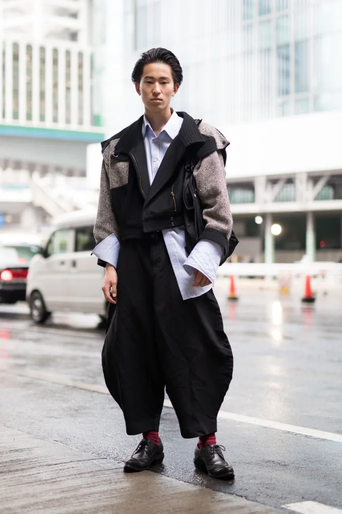 A guest wearing a black and grey coat at the Tokyo Fashion Week