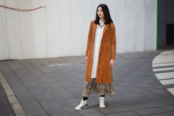 A guest at the Amazon Fashion Week Tokyo wearing white sneakers