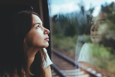 A woman looking out of a train window