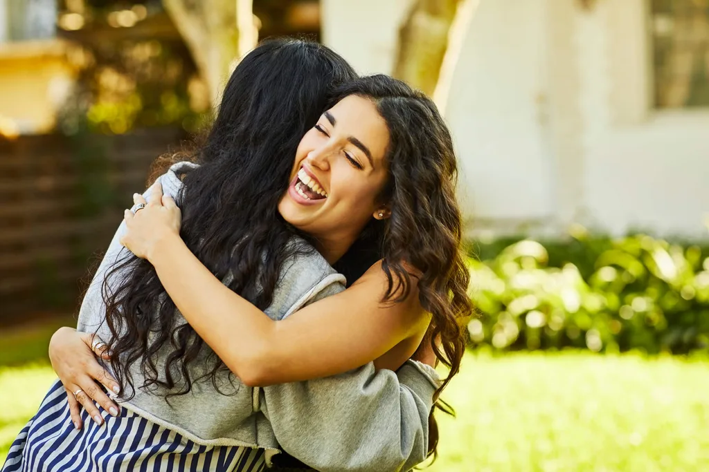 Two friends hugging in a park