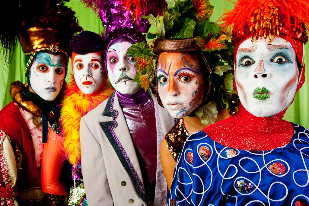 A row of clowns in colourful clothing