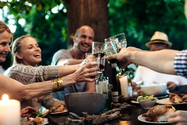 A family clinking glasses over a dinner