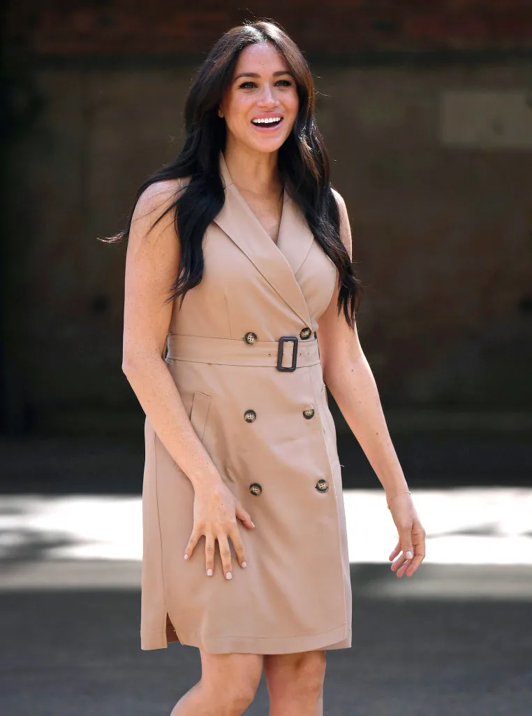 Meghan, the Duchess of Sussex, dressed in a beige tuxedo dress
