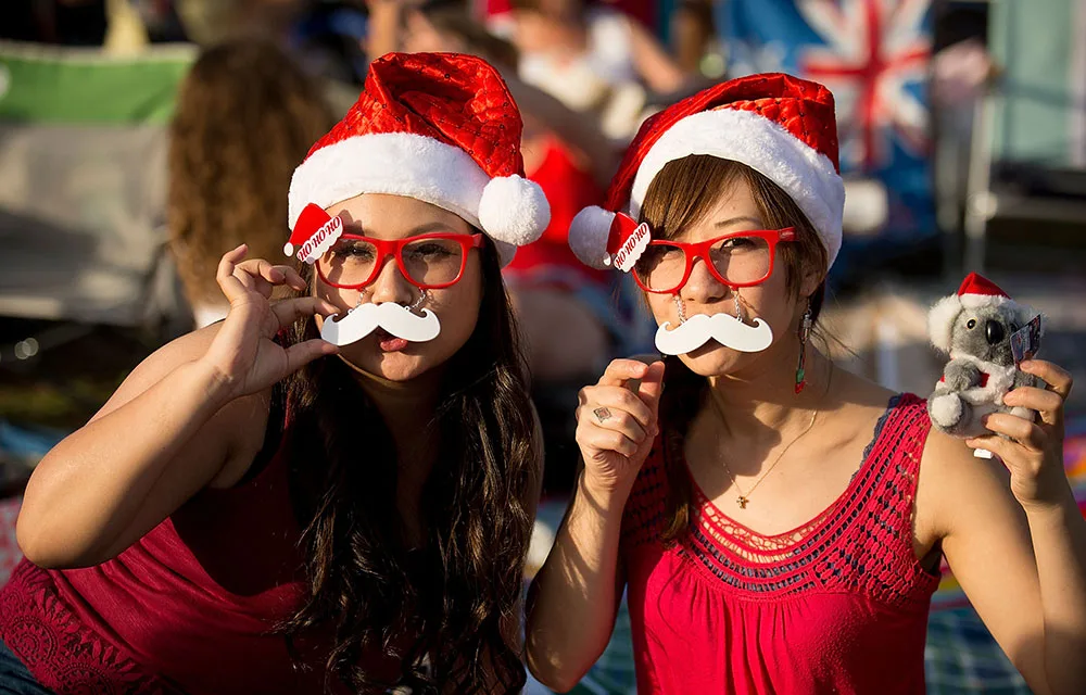 Girls dressed up as Santa at Carols in the domain