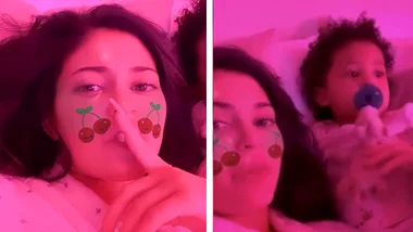 Stormi shooshes Kylie as they watch Frozen 2