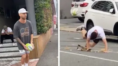 Quade Cooper kicks a ball at his friend carrying coffee