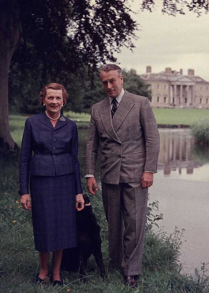 Earl Mountbatten of Burma and Lady Edwina Mountbatten walking in the grounds of Broadlands, their Hampshire home, with their dog.