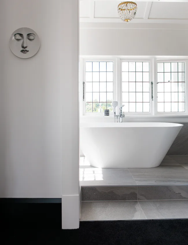 he-couple&rsquo;s-large-ensuite-features-a-freestanding-bathtub-and-shower-doors