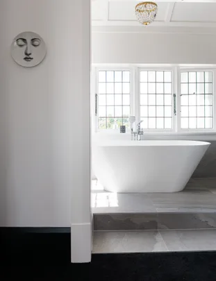 he-couple’s-large-ensuite-features-a-freestanding-bathtub-and-shower-doors