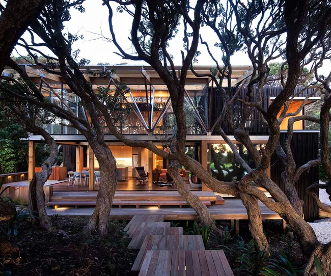 The 2012 Home of the Year, located in a grove of pohutukawa at Piha Beach, was designed by Herbst Architects. Photograph by Patrick Reynolds.
