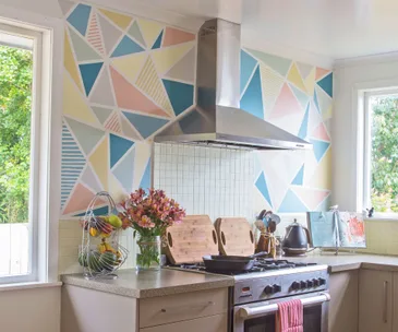 A beige kitchen gets a colourful paint job