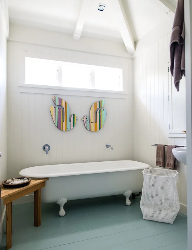 The colourful bathroom art is by Fane Flaws.