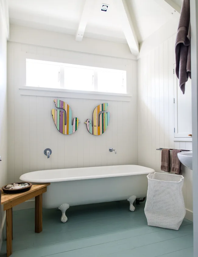 The colourful bathroom art is by Fane Flaws.