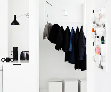 hallway, water pipe clothes rack, white boxes