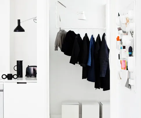 hallway, water pipe clothes rack, white boxes