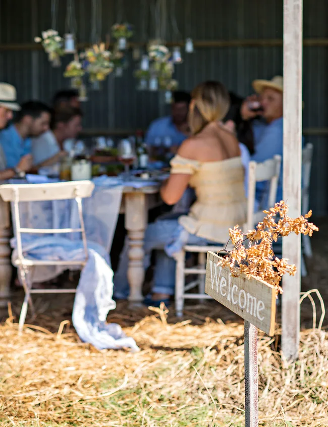 The beautifully set table in the shade of the barn