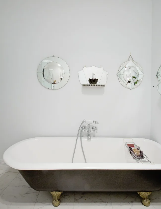Clawfoot bath, vintage mirrors, bathroom