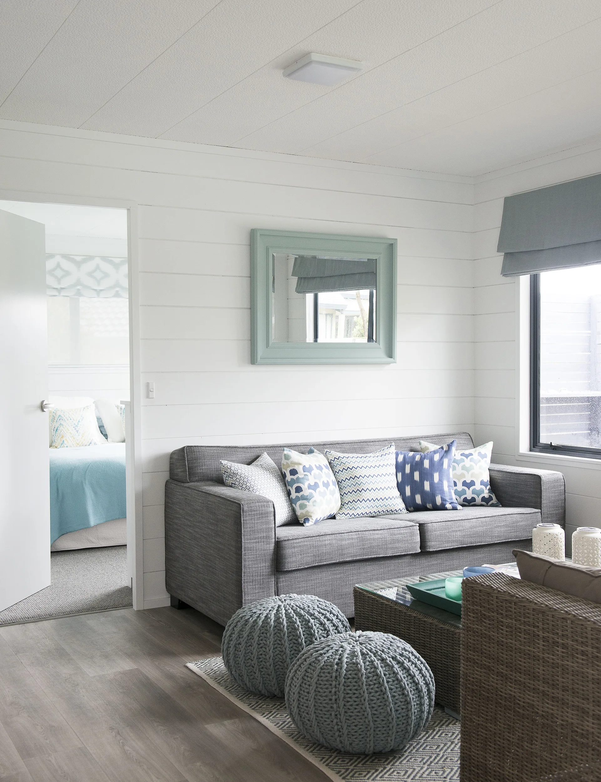 The open-plan living space converts into a sleeping area with a fold-out couch. 