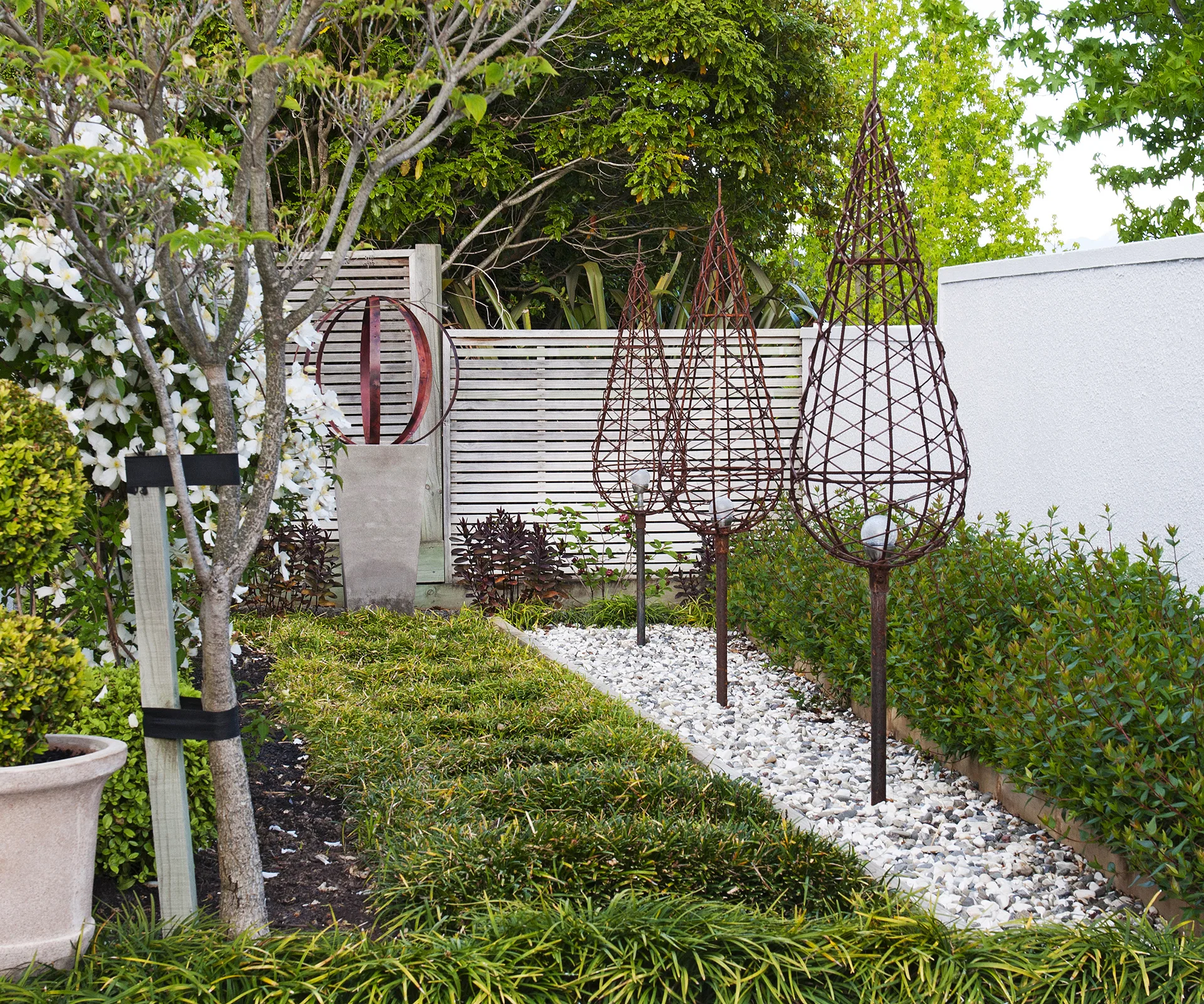 Also in the front part of the garden is a row of conical steel sculptures plus a steel sphere Dianne made herself from an old wine barrel, mounted on a concrete plinth.