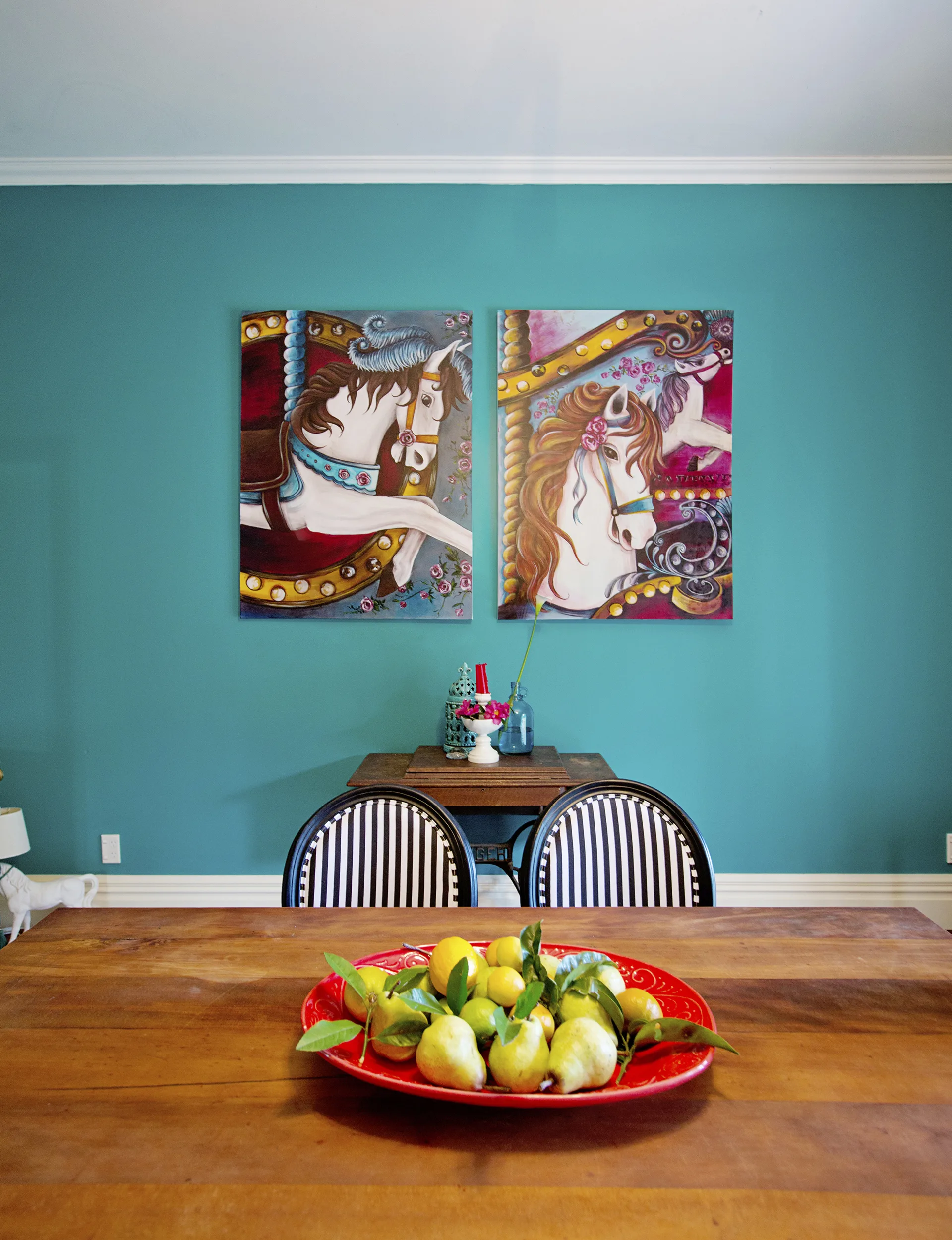 Vibrant art and layers of print and pattern bring interest, texture and fun to the substantial dining space. The room’s warm timber flooring is offset by the punchy aqua tones of Resene ‘Surfie Green’ on the walls.