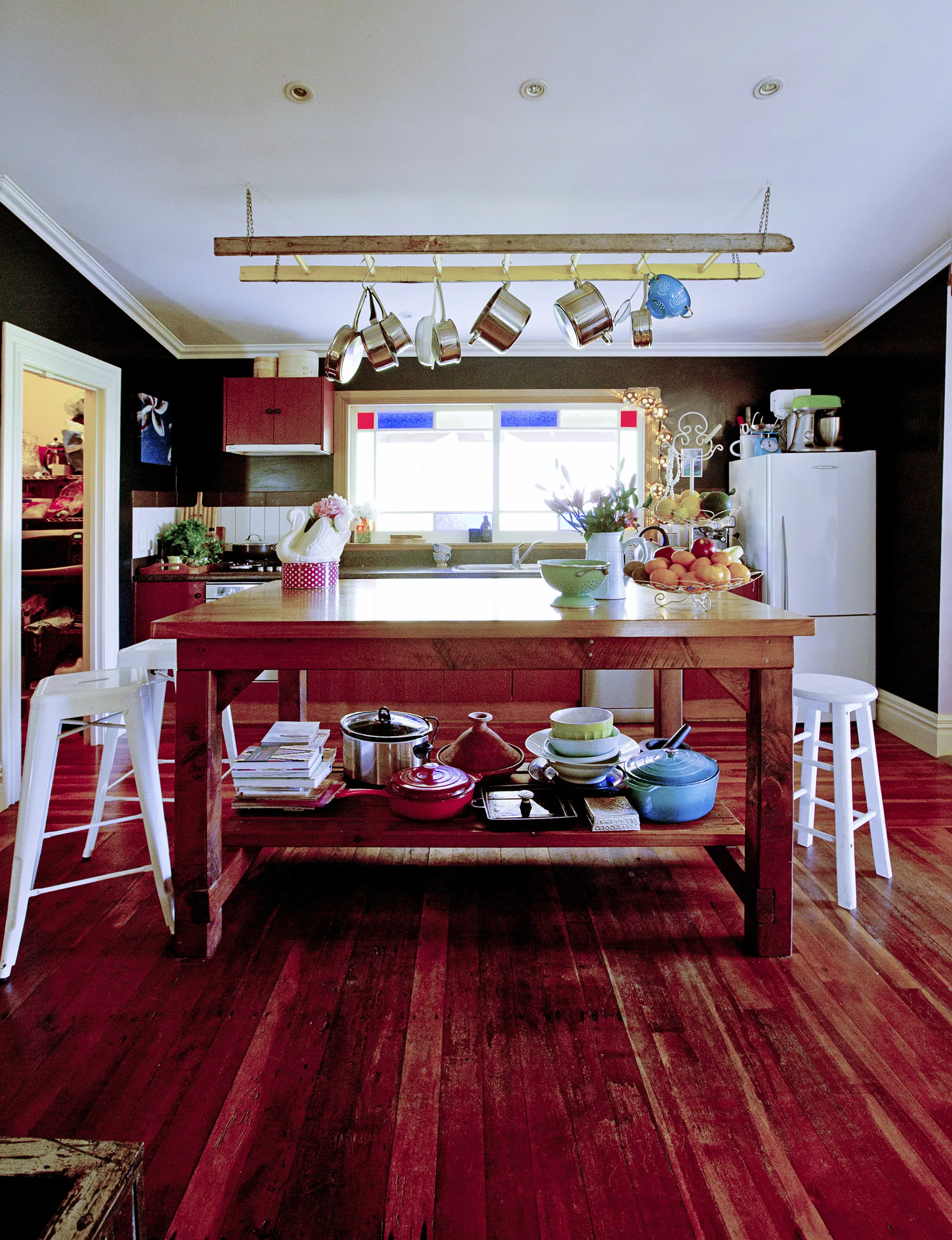 The farmhouse-style kitchen is situated on the southern side of the house, so the space is naturally darker than the north-facing living areas.