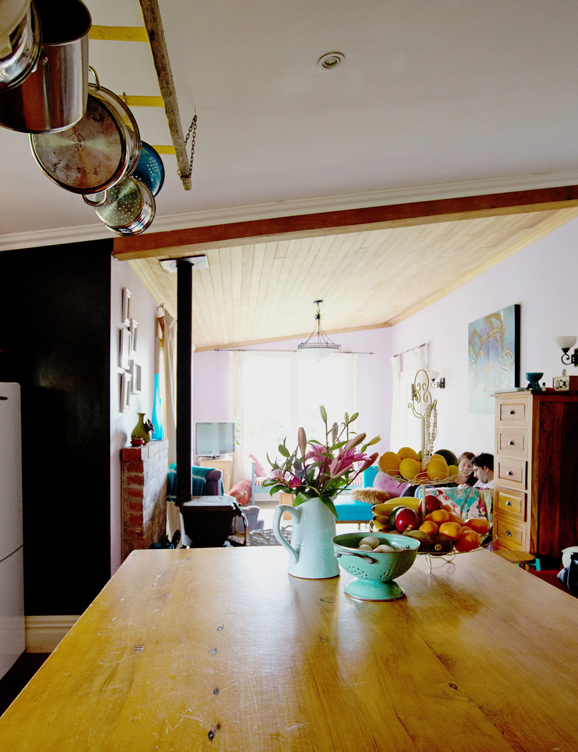 Kim painted the kitchen black to give the traditional farmhouse space a contemporary lift, with colour making an appearance via the stained glass and kitchenware. 