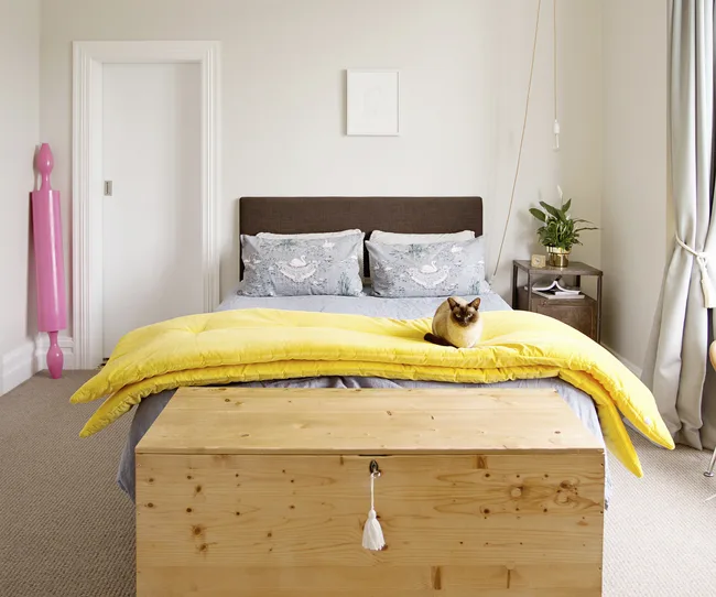 Neutral tones in the master bedroom are brought to life with colourful bedlinen.
