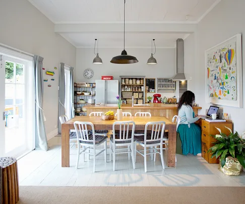 In the kitchen and dining area the original timber floorboards have been painted white .