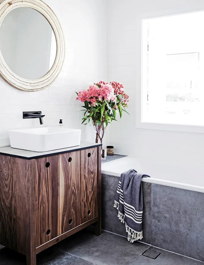 The completely renovated bathroom features a custom made vanity.