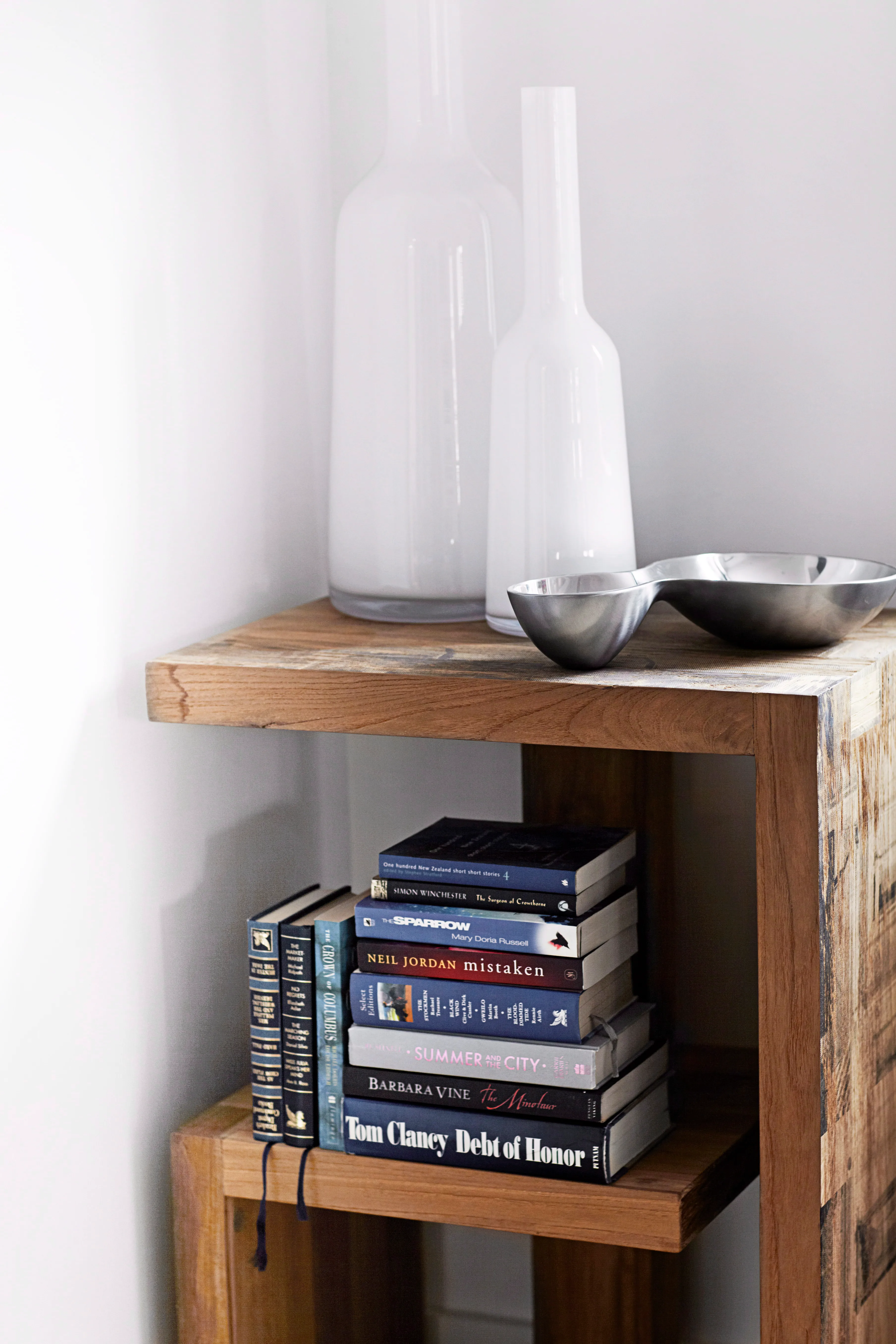 A pair of Villeroy & Boch vases sit atop a timber shelf.
