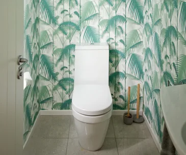 Statement wallpaper helped to make this cold bach bathroom pop