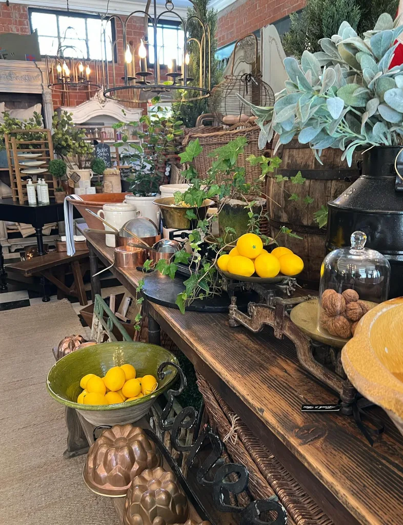 Inside French & Sons, with console tables full of bowls, vases, baking tins and other second-hand homewares.