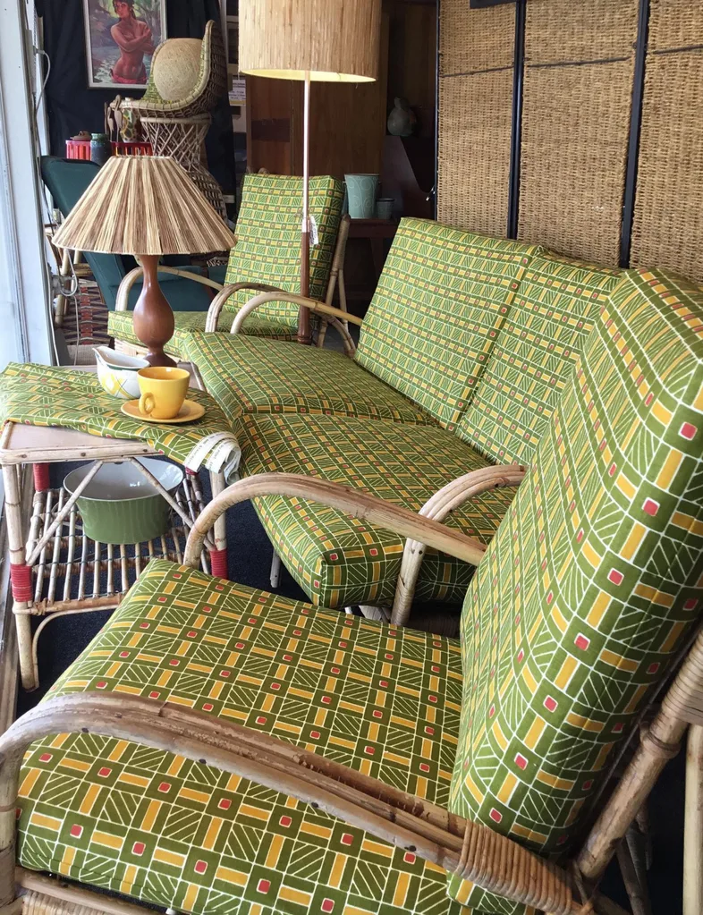 A display at Eclectic Antique Centre in Nelson, with matching green outdoor cane couches and armchairs.