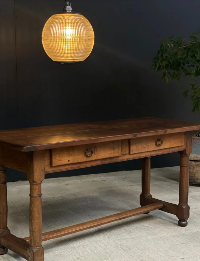 A console table on display at L'Original, a second-hand store in Hastings. A glass pendant light hangs above it.