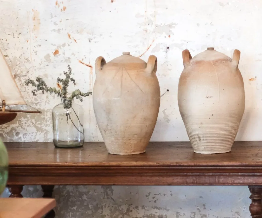Two ceramic urns sit on a wooden console table in Vintage Industries, a second-hand furniture store in New Plymouth.