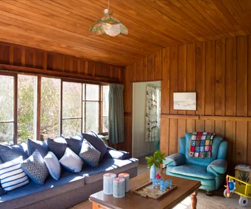 A coastal bach in Waikuku has retained its vintage vibe
