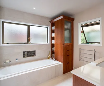 Savvy storage and sleek design has freshened up this Auckland bathroom