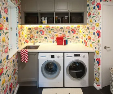 Bright wallpaper helps to liven up a dull laundry room