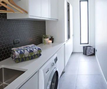 An Auckland home gets a generous black and white laundry