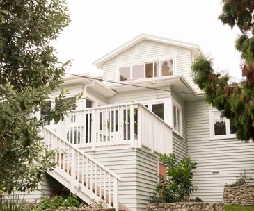 The plain facade of this Auckland home hides a vintage inspired interior