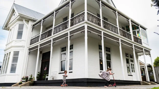 Children scootering around a modernised Oamaru villa