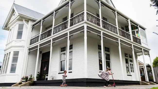 Children scootering around a modernised Oamaru villa