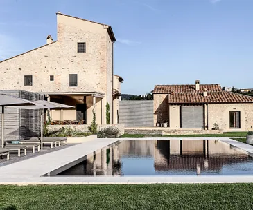 An old farmstead is split in half to fit two sisters and their families
